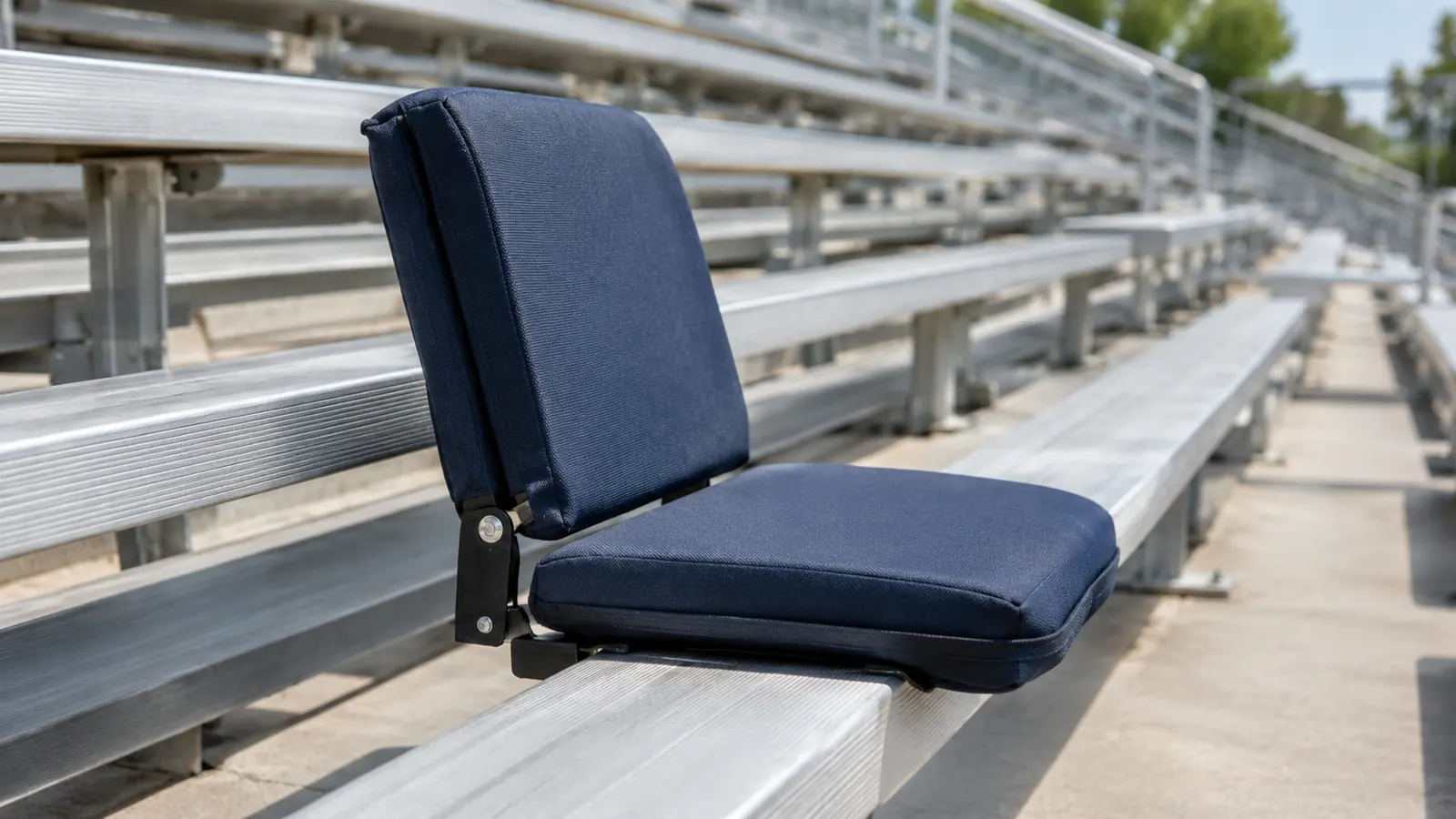 A stadium seat with back support clipped onto a metal bleacher bench, viewed from the side